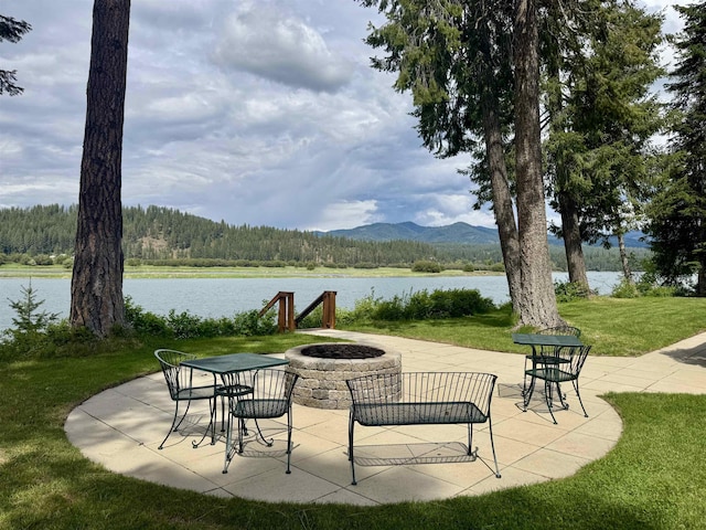 812 Levitch Rd, Newport, WA 99156 - view of patio featuring an outdoor fire pit, a water and mountain view, and a view of trees