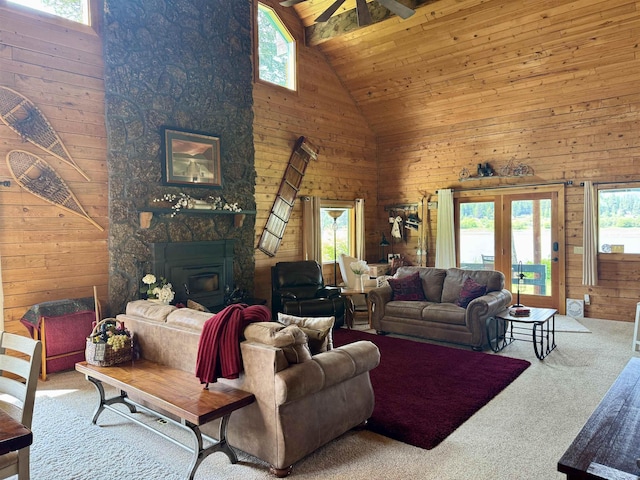 812 Levitch Rd, Newport, WA 99156 - carpeted living room with high vaulted ceiling, wood walls, plenty of natural light, a ceiling fan, and wooden ceiling
