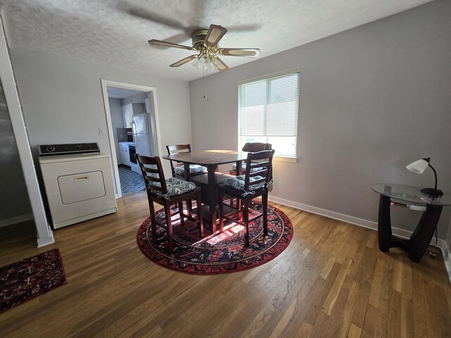 405 S Coeur Dalene St Unit 11, Spokane, WA 99201 - dining area featuring washer / clothes dryer, wood finished floors, a ceiling fan, baseboards, and a textured ceiling