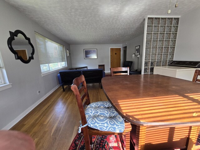 405 S Coeur Dalene St Unit 11, Spokane, WA 99201 - dining space with wood finished floors, a textured ceiling, and baseboards