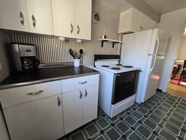 405 S Coeur Dalene St Unit 11, Spokane, WA 99201 - kitchen with white electric range, dark countertops, dark floors, open shelves, and white cabinets