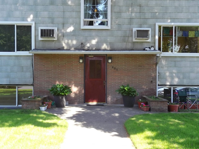 405 S Coeur Dalene St Unit 11, Spokane, WA 99201 - view of exterior entry with brick siding and a wall mounted AC