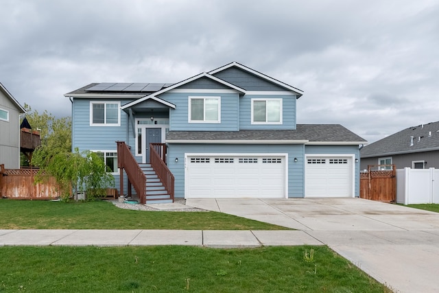 8566 N Oak St, Spokane, WA 99208 - view of front facade featuring concrete driveway, roof mounted solar panels, and an attached garage