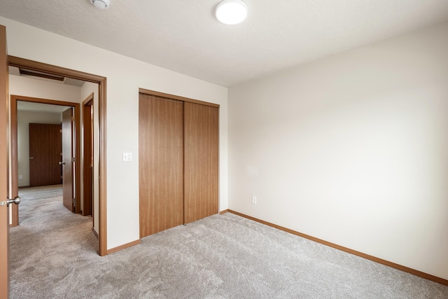 8566 N Oak St, Spokane, WA 99208 - unfurnished bedroom with light colored carpet, a closet, and baseboards