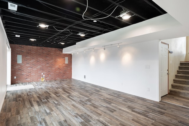 8566 N Oak St, Spokane, WA 99208 - finished basement featuring brick wall, rail lighting, stairway, and wood finished floors
