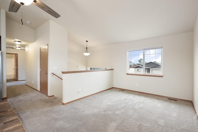 8566 N Oak St, Spokane, WA 99208 - carpeted spare room with lofted ceiling, ceiling fan, baseboards, and wood finished floors