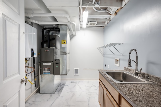 8566 N Oak St, Spokane, WA 99208 - washroom with washer hookup, marble finish flooring, water heater, baseboards, and cabinet space