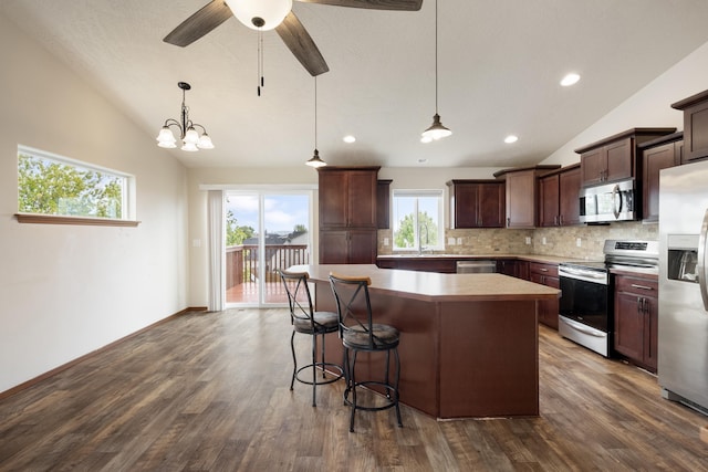 8566 N Oak St, Spokane, WA 99208 - kitchen featuring stainless steel appliances, lofted ceiling, a kitchen island, backsplash, and a sink