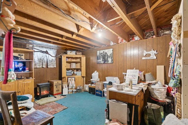 2029 E Sharp Ave, Spokane, WA 99202 - below grade area featuring a wood stove, carpet, and wooden walls