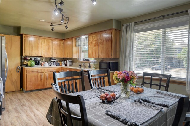301 E Ermina Ave, Spokane, WA 99207 - kitchen with black microwave, light countertops, light wood finished floors, track lighting, and a sink