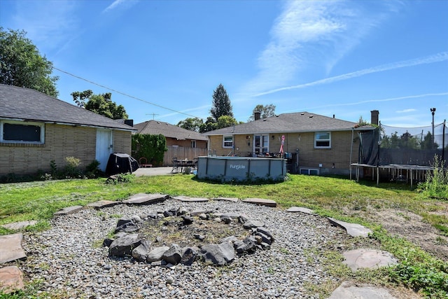 301 E Ermina Ave, Spokane, WA 99207 - view of yard with a trampoline, a patio, and a fire pit