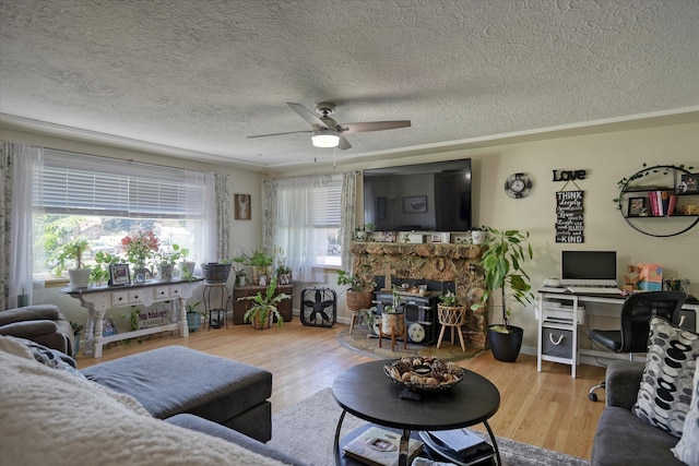 301 E Ermina Ave, Spokane, WA 99207 - living area with a textured ceiling, wood finished floors, a ceiling fan, a fireplace, and an office area