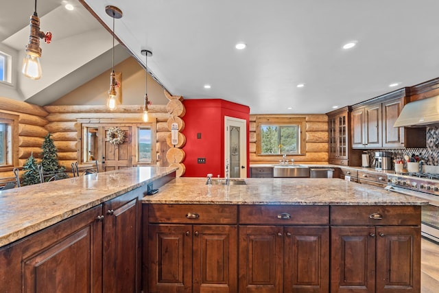 33905 Winterwood Ln Unit E, Davenport, WA 99122 - kitchen featuring log walls, appliances with stainless steel finishes, a sink, recessed lighting, and glass insert cabinets