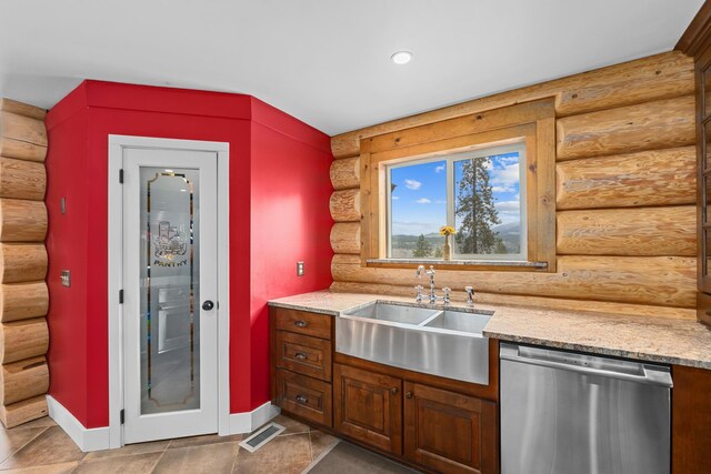 33905 Winterwood Ln Unit E, Davenport, WA 99122 - kitchen featuring stainless steel dishwasher, rustic walls, a sink, baseboards, and light stone countertops