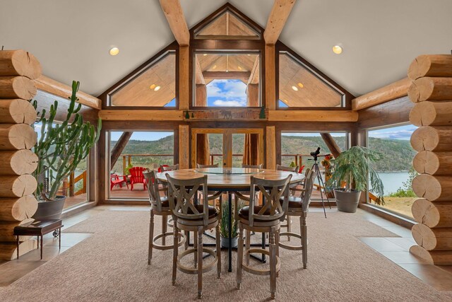 33905 Winterwood Ln Unit E, Davenport, WA 99122 - dining room featuring rustic walls, high vaulted ceiling, plenty of natural light, beam ceiling, and tile patterned floors