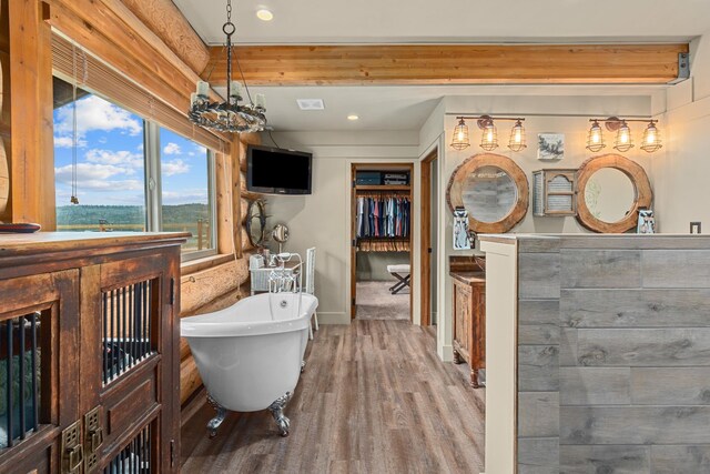 33905 Winterwood Ln Unit E, Davenport, WA 99122 - bathroom with a freestanding bath, wood finished floors, a walk in closet, recessed lighting, and baseboards