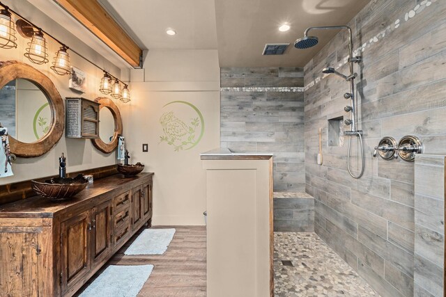 33905 Winterwood Ln Unit E, Davenport, WA 99122 - bathroom featuring double vanity, wood finished floors, walk in shower, and recessed lighting