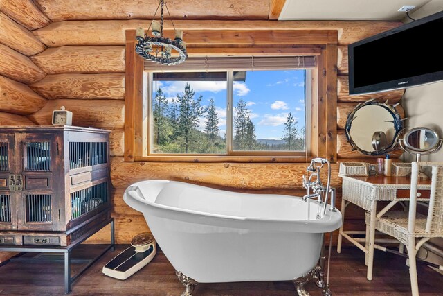 33905 Winterwood Ln Unit E, Davenport, WA 99122 - bathroom with rustic walls, a freestanding tub, and wood finished floors