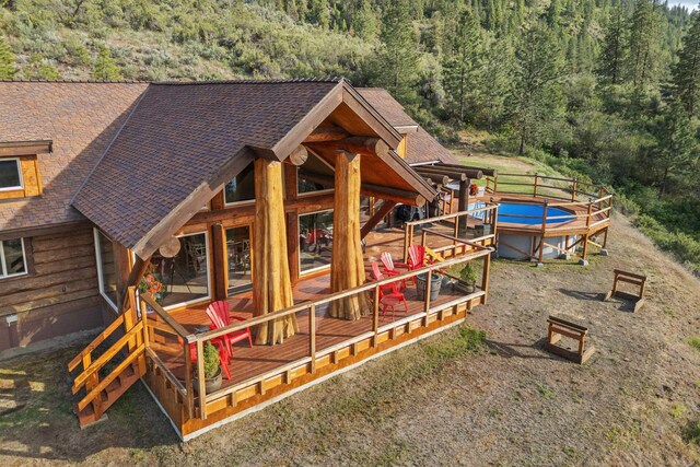 33905 Winterwood Ln Unit E, Davenport, WA 99122 - view of playground featuring a forest view and a wooden deck