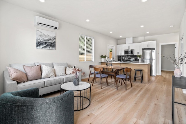 2424 N Addison St, Spokane, WA 99207 - living area featuring a wall unit AC, recessed lighting, light wood finished floors, and baseboards