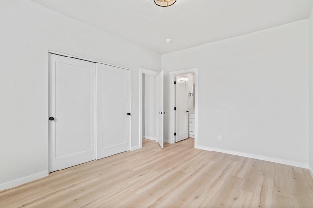 2424 N Addison St, Spokane, WA 99207 - unfurnished bedroom with wood finished floors, baseboards, a closet, and ensuite bath