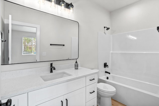 2424 N Addison St, Spokane, WA 99207 - bathroom featuring vanity, toilet, washtub / shower combination, and wood finished floors