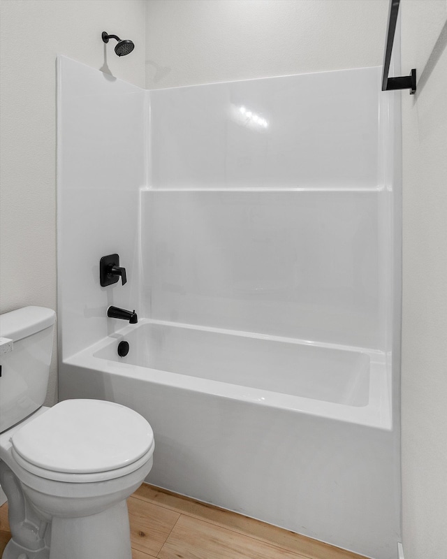 2424 N Addison St, Spokane, WA 99207 - bathroom featuring toilet,  shower combination, and wood finished floors