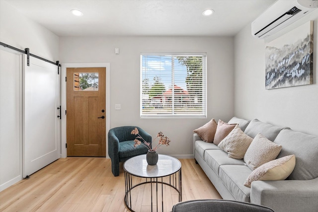 2424 N Addison St, Spokane, WA 99207 - living area featuring a wall mounted air conditioner, a barn door, light wood finished floors, recessed lighting, and baseboards