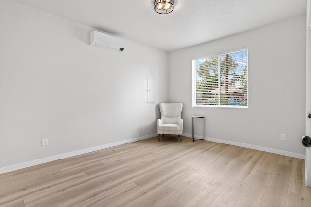2424 N Addison St, Spokane, WA 99207 - unfurnished room featuring a wall unit AC, light wood finished floors, and baseboards