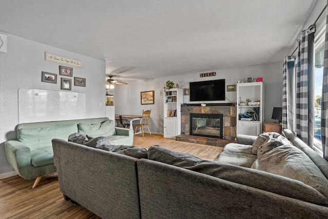 3006 W Francis Ave, Spokane, WA 99205 - living area with wood finished floors, a tiled fireplace, baseboards, and plenty of natural light