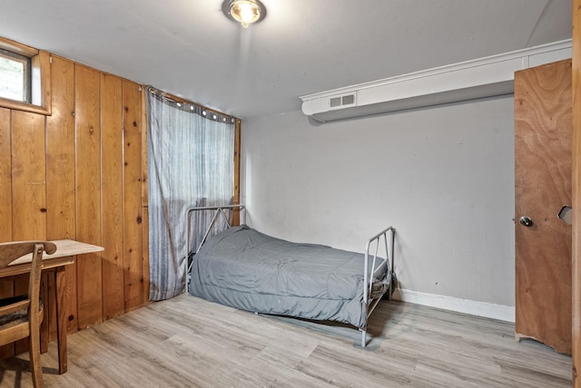 3006 W Francis Ave, Spokane, WA 99205 - bedroom featuring wood finished floors, wood walls, and baseboards