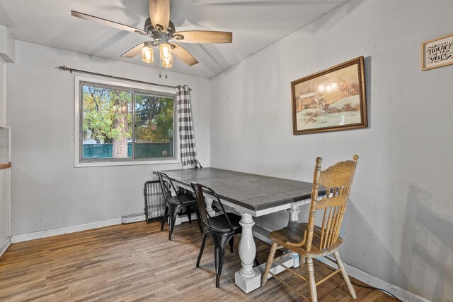 3006 W Francis Ave, Spokane, WA 99205 - dining space with light wood-style floors, ceiling fan, baseboards, and a baseboard heating unit