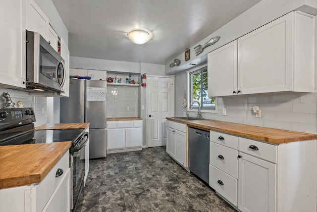 3006 W Francis Ave, Spokane, WA 99205 - kitchen with wood counters, stainless steel appliances, a sink, and backsplash