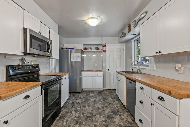 3006 W Francis Ave, Spokane, WA 99205 - kitchen with stainless steel appliances, wooden counters, a sink, decorative backsplash, and white cabinets