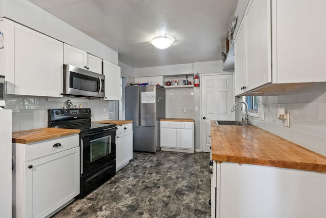 3006 W Francis Ave, Spokane, WA 99205 - kitchen featuring wood counters, stainless steel appliances, a sink, and decorative backsplash