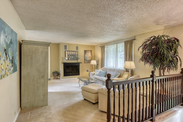 1829 S Glenrose Rd, Spokane, WA 99223 - carpeted living area with a textured ceiling, a fireplace, and baseboards