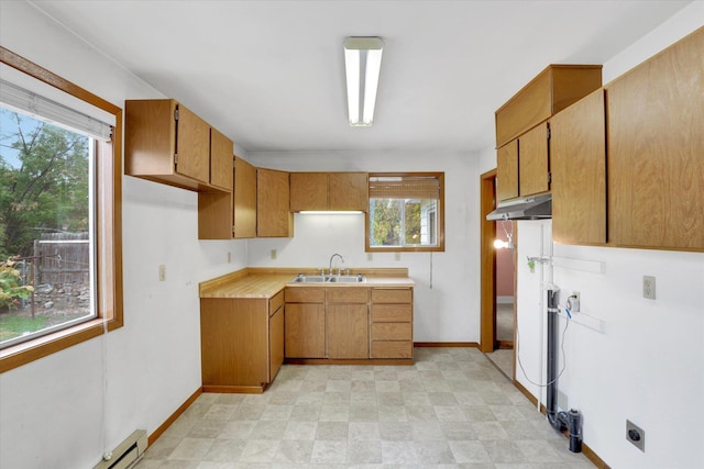 603 E Providence Ave, Spokane, WA 99207 - kitchen with a sink, a baseboard heating unit, light countertops, and plenty of natural light