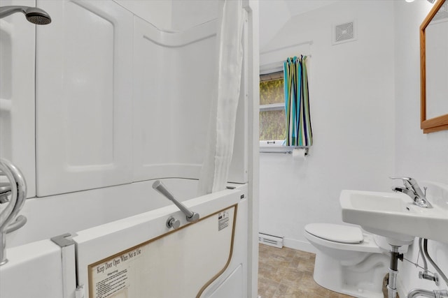 603 E Providence Ave, Spokane, WA 99207 - bathroom with baseboards, toilet, stone finish floors, and shower / bath combination with curtain