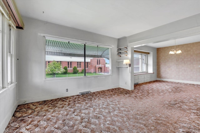 603 E Providence Ave, Spokane, WA 99207 - carpeted spare room featuring a chandelier and baseboards