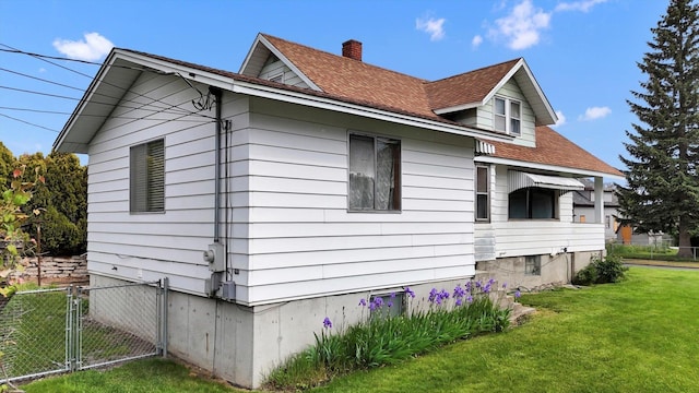 603 E Providence Ave, Spokane, WA 99207 - view of side of property featuring a shingled roof, a gate, and a chimney