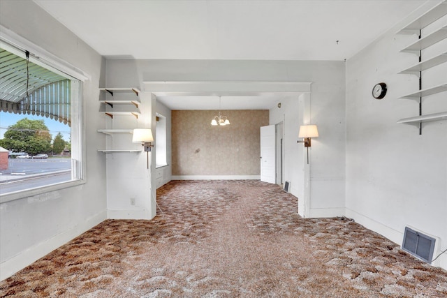 603 E Providence Ave, Spokane, WA 99207 - spare room featuring a chandelier, carpet floors, and baseboards