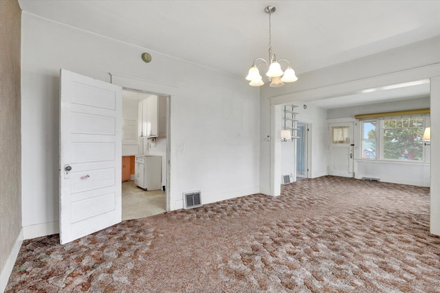 603 E Providence Ave, Spokane, WA 99207 - carpeted empty room with a chandelier, baseboards, and a smoke detector