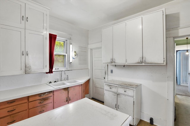 603 E Providence Ave, Spokane, WA 99207 - kitchen with a sink, light countertops, and white cabinetry