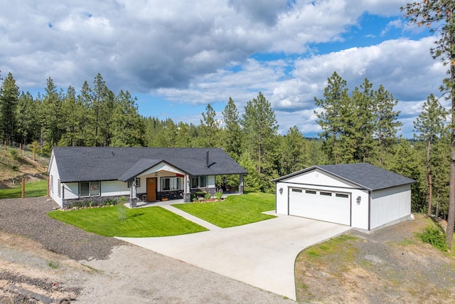 5475 Peggy Way, Deer Park, WA 99006 - view of front of house featuring a front yard, an outdoor structure, a garage, a forest view, and covered porch