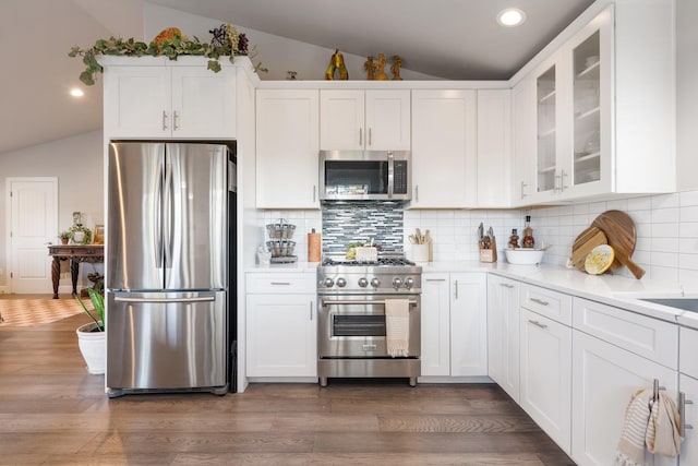 5475 Peggy Way, Deer Park, WA 99006 - kitchen with stainless steel appliances, lofted ceiling, white cabinetry, glass insert cabinets, and light countertops