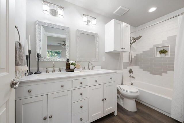 5475 Peggy Way, Deer Park, WA 99006 - full bath featuring double vanity, wood finished floors, shower / bathtub combination with curtain, toilet, and recessed lighting