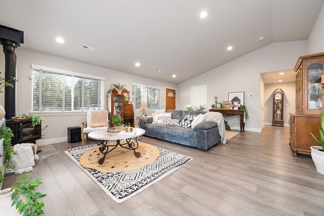 5475 Peggy Way, Deer Park, WA 99006 - living room with a wood stove, vaulted ceiling, light wood-style flooring, recessed lighting, and baseboards
