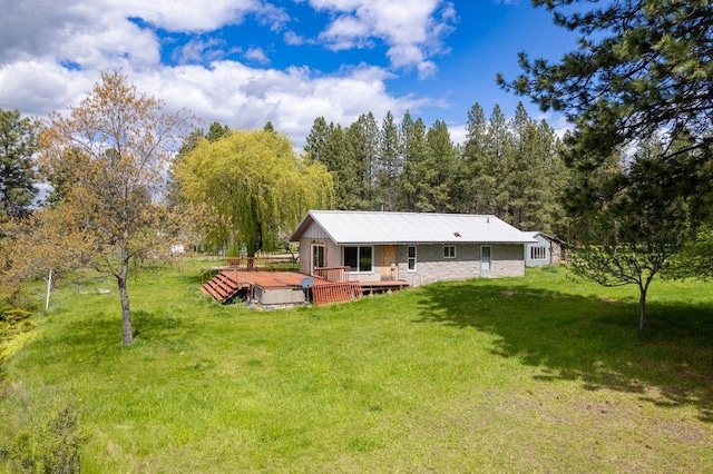 472 Snow Berry Ln, Usk, WA 99180 - back of house featuring a deck, a lawn, and metal roof