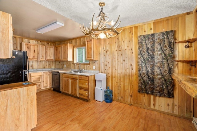 472 Snow Berry Ln, Usk, WA 99180 - kitchen with black appliances, a sink, a chandelier, wood walls, and light countertops