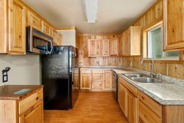 472 Snow Berry Ln, Usk, WA 99180 - kitchen featuring stainless steel microwave, a sink, dishwashing machine, light wood-style floors, and freestanding refrigerator